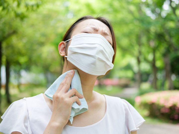 夏にマスクを着用した若いアジアの女性