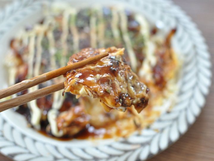 餅お好み焼きを箸で持ち上げている様子