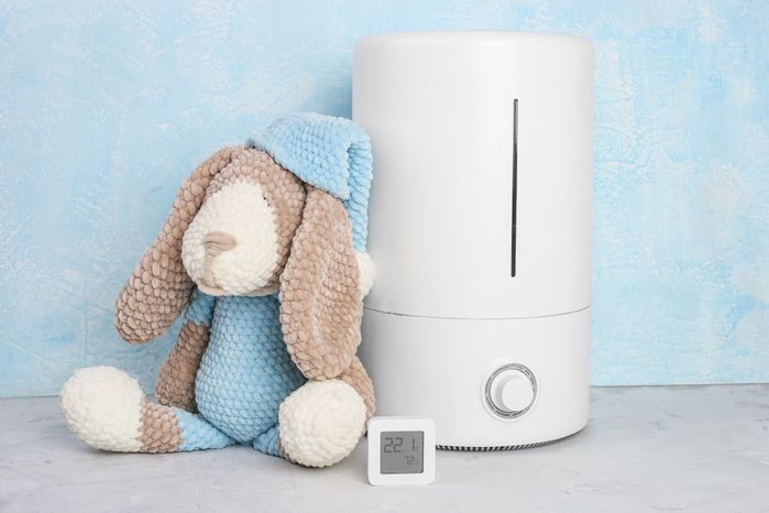 空気加湿器および電子吸湿計。ニットおもちゃの犬。子供の部屋の湿度。クローズアップ