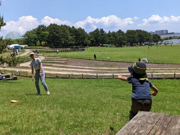 大きな公園でキャッチボールをする、近藤さんと息子さん。