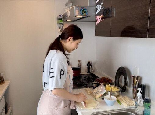 自宅のキッチンで料理中の西野さん。