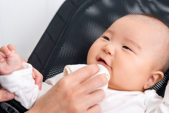 ガーゼで赤ちゃんの顔を拭く