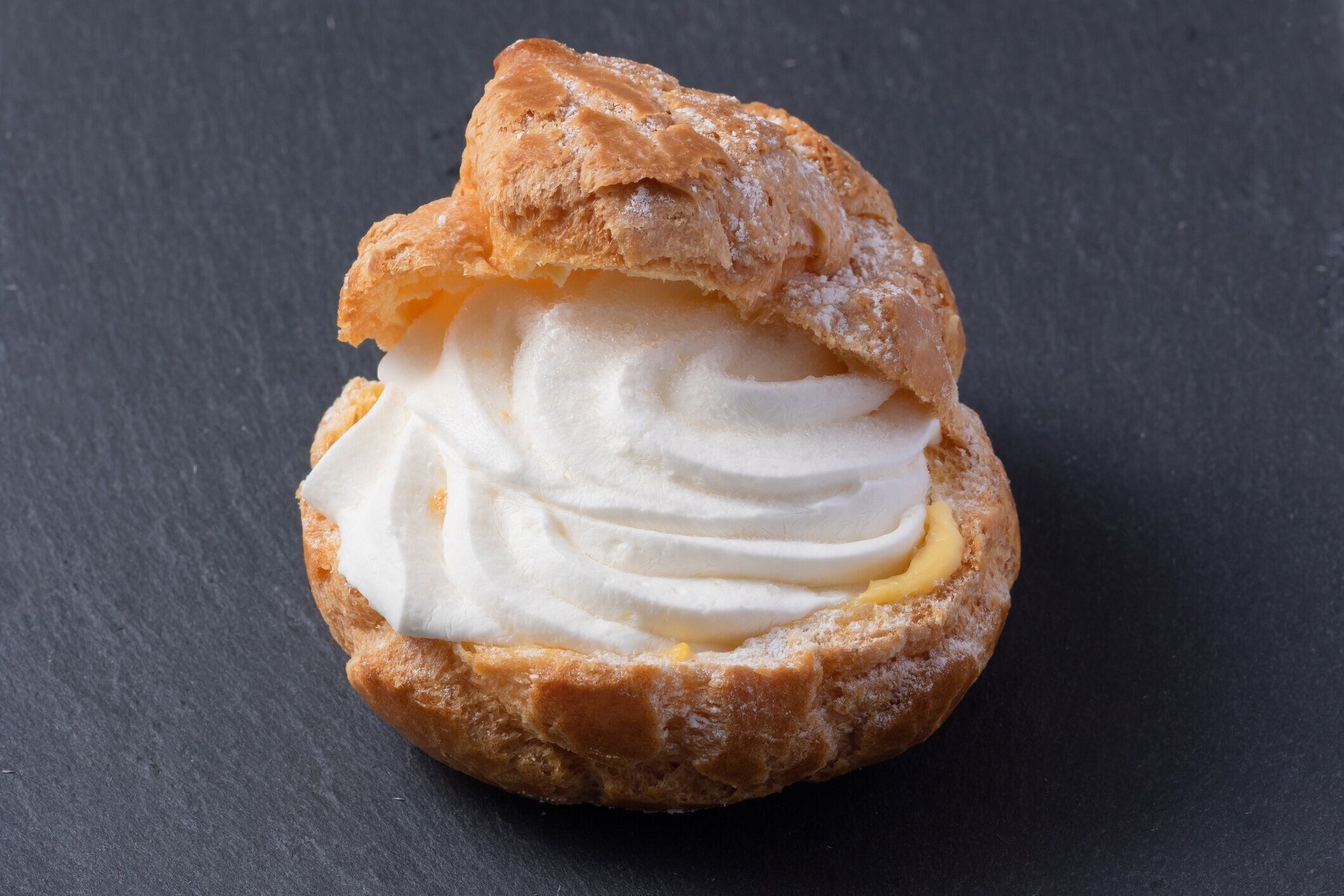 シンプルな黒の背景にシュークリーム