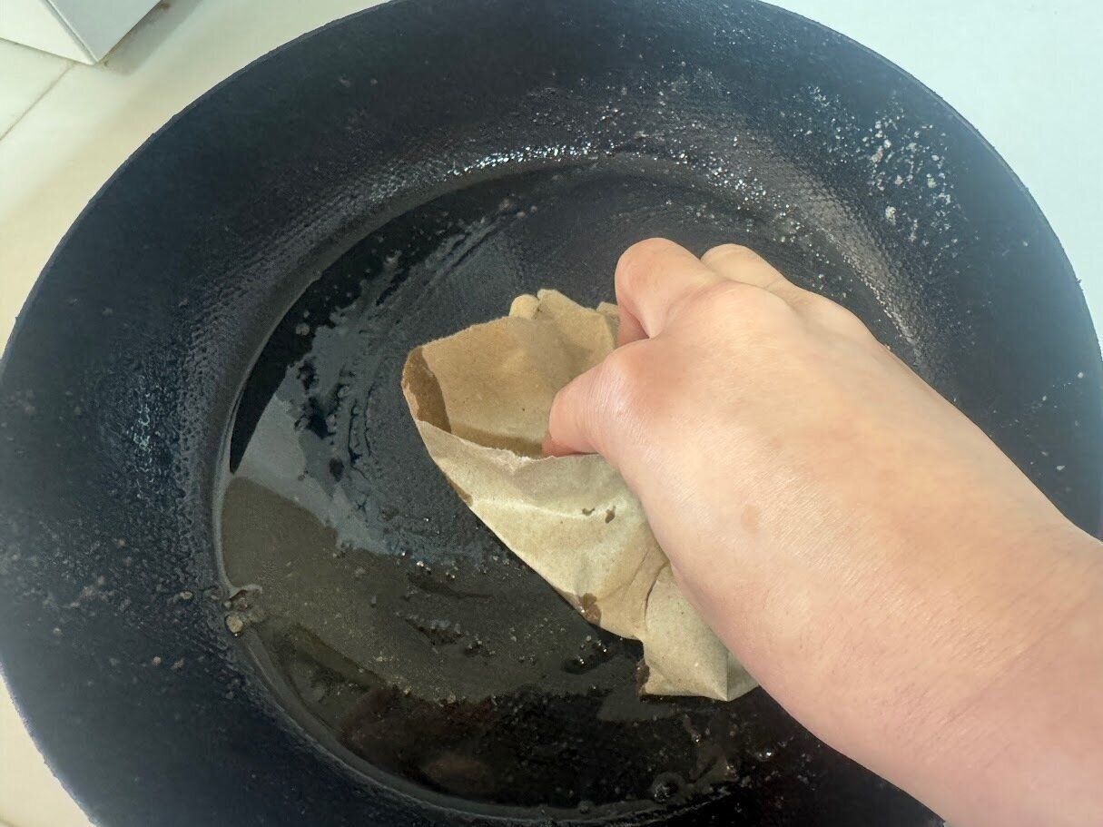 フライパンの汚れを紙の緩衝材で拭き取る