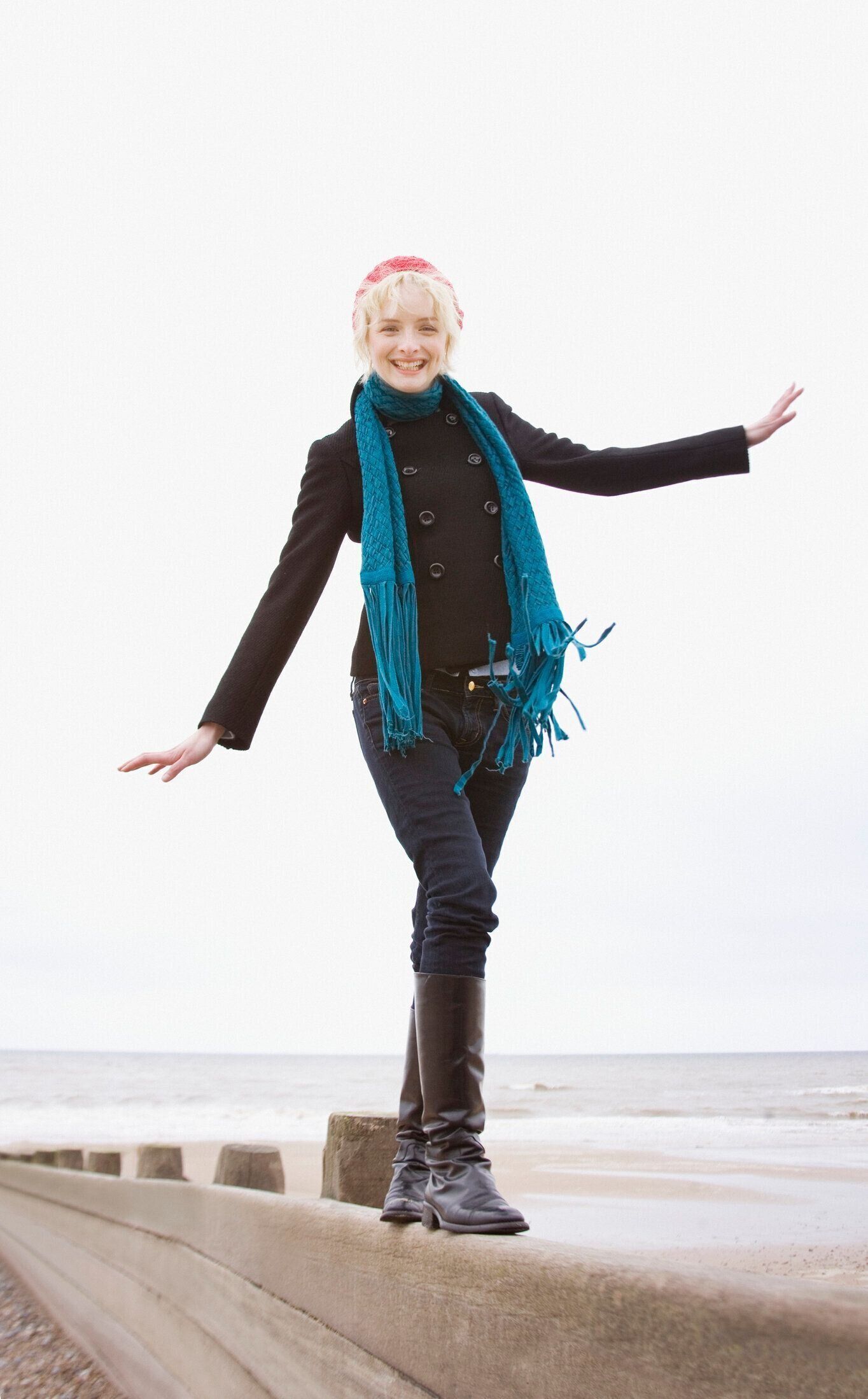 女性のバランスを整え、ビーチでの壁