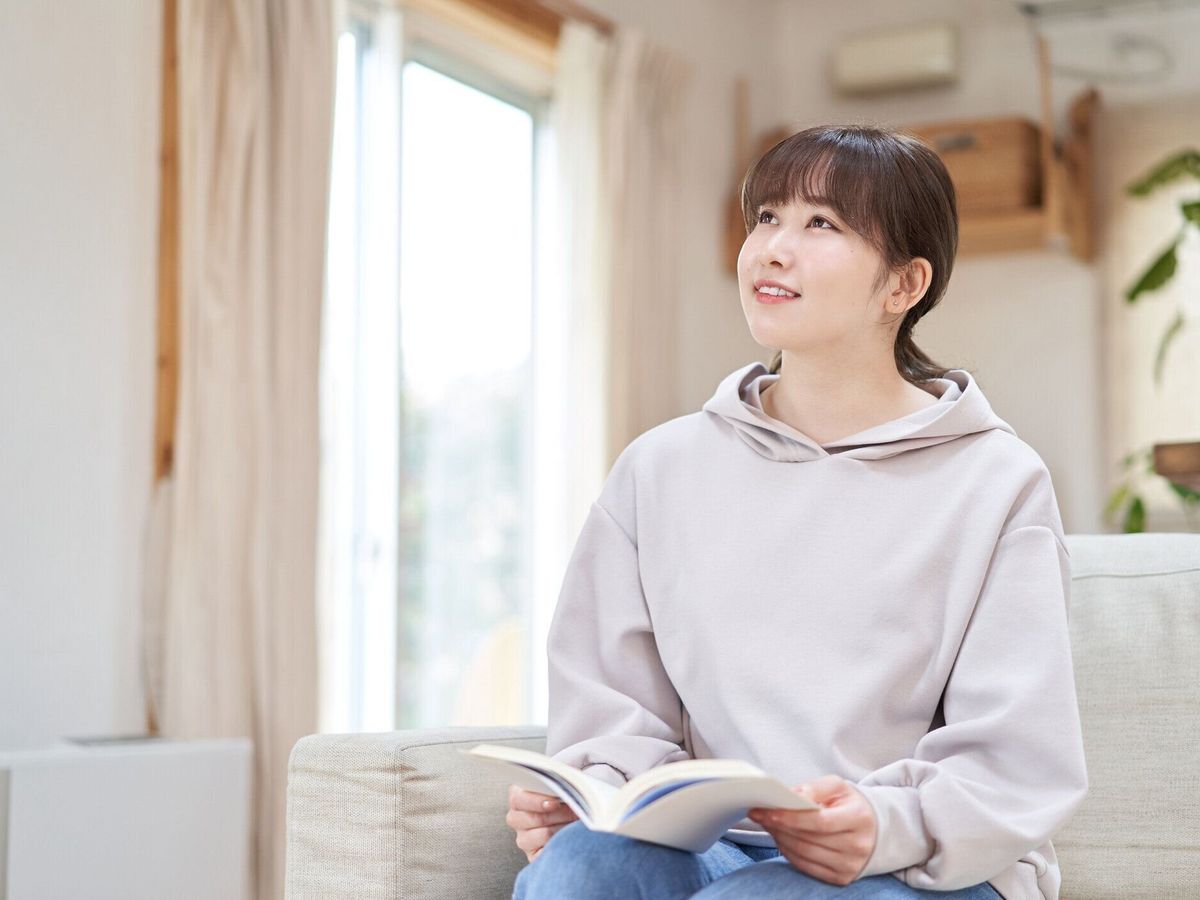 自宅で本を読むアジアの女性