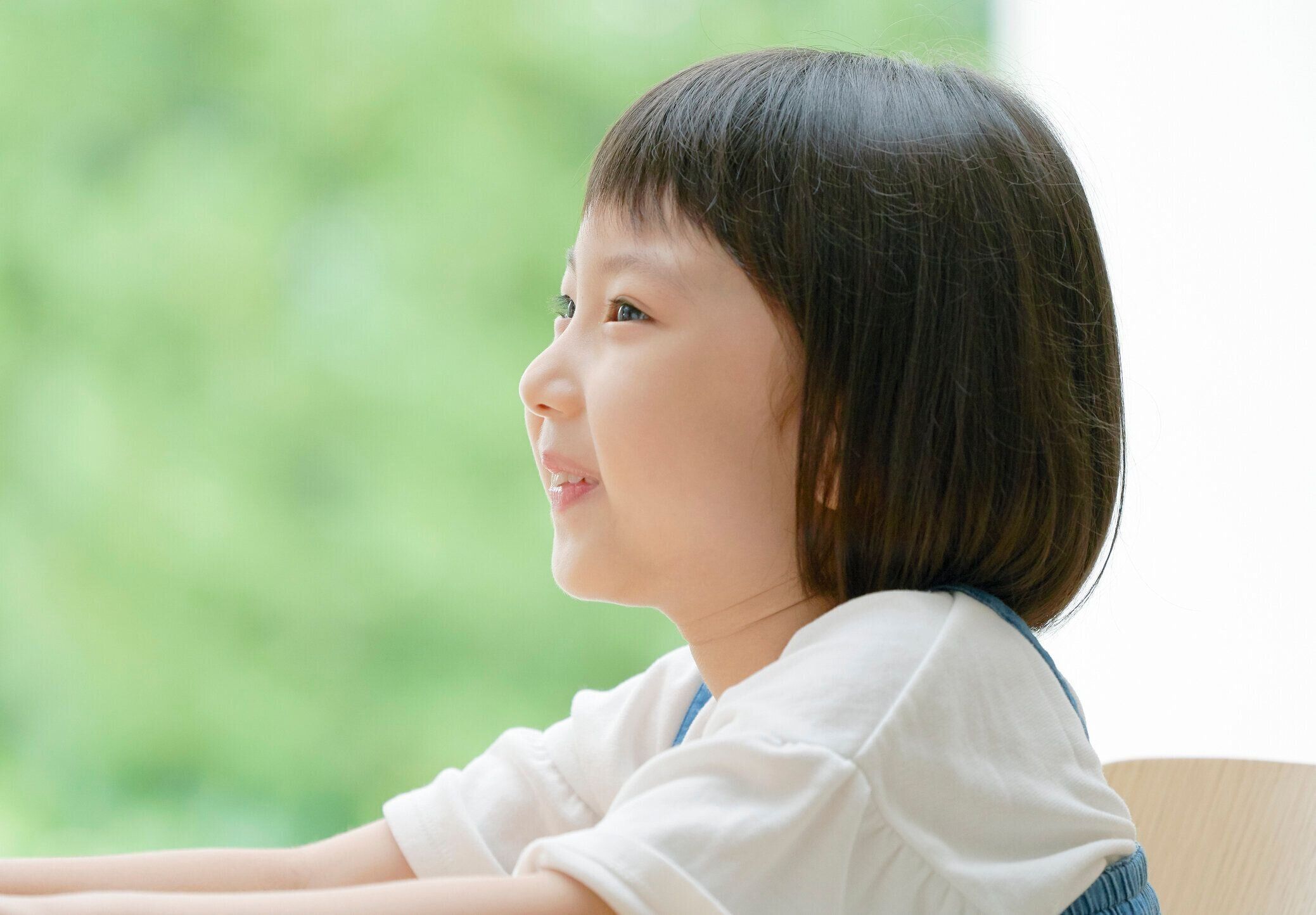 椅子に微笑むアジアの女の子