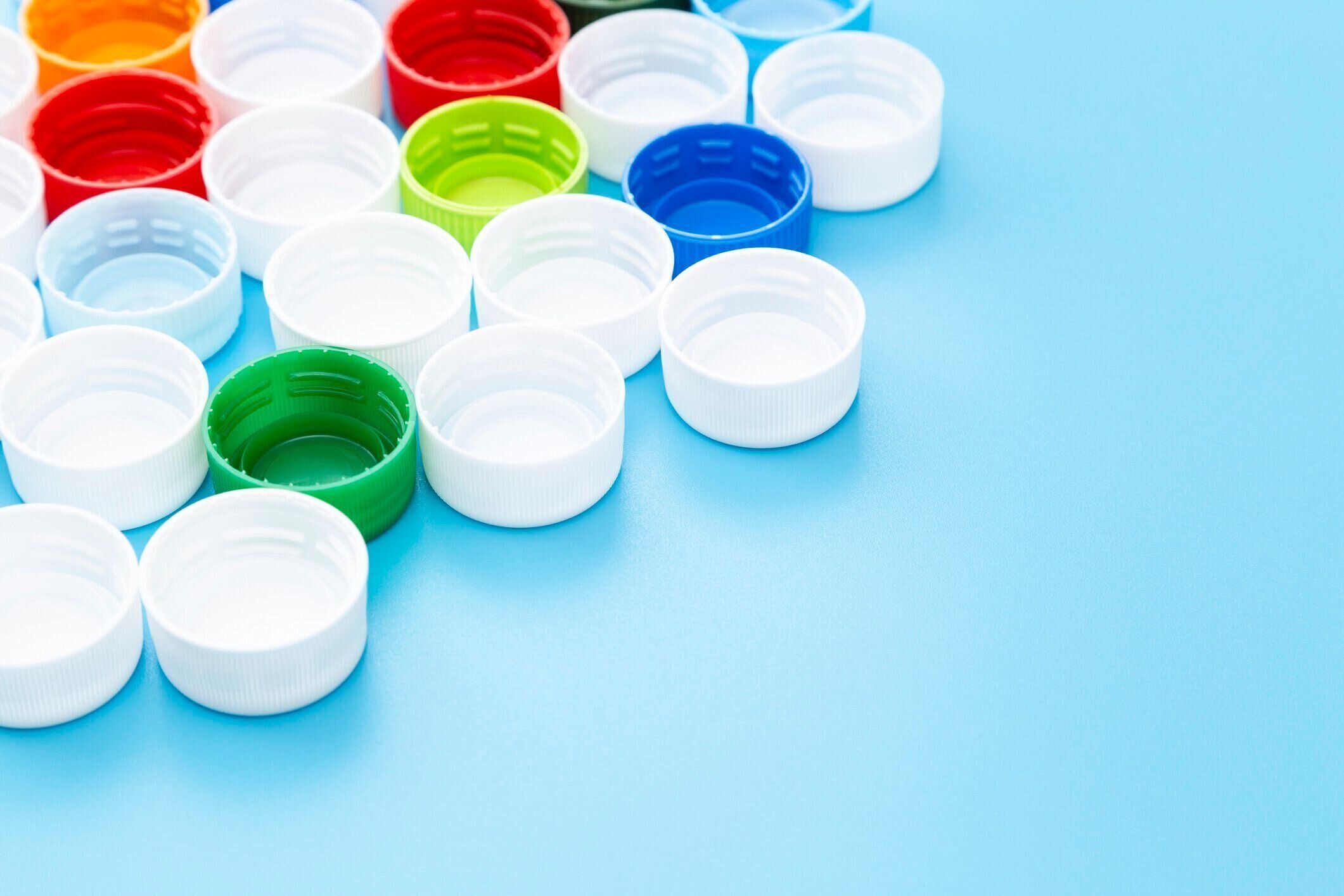 青の背景に配置されたボトルキャップ