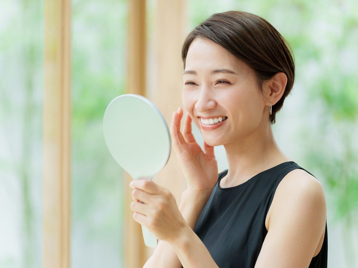 黒いドレスを着た魅力的なアジア人女性、鏡