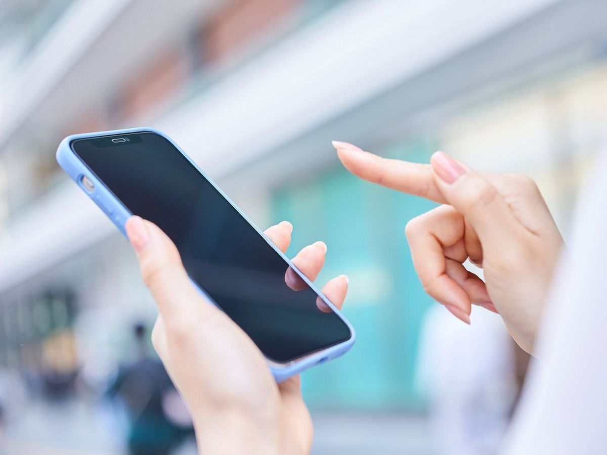 街角でスマホを使う女性
