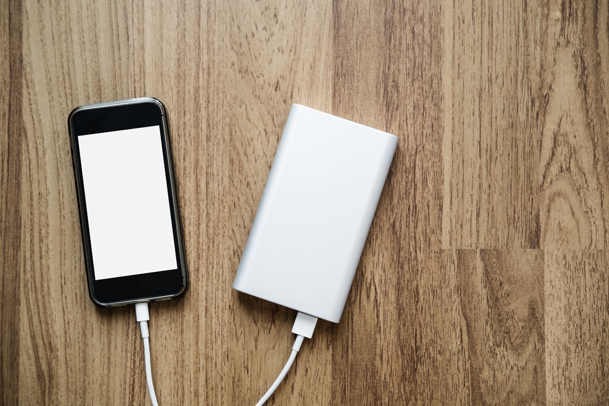 ウッド テクスチャに電源銀行と充電スマート フォン