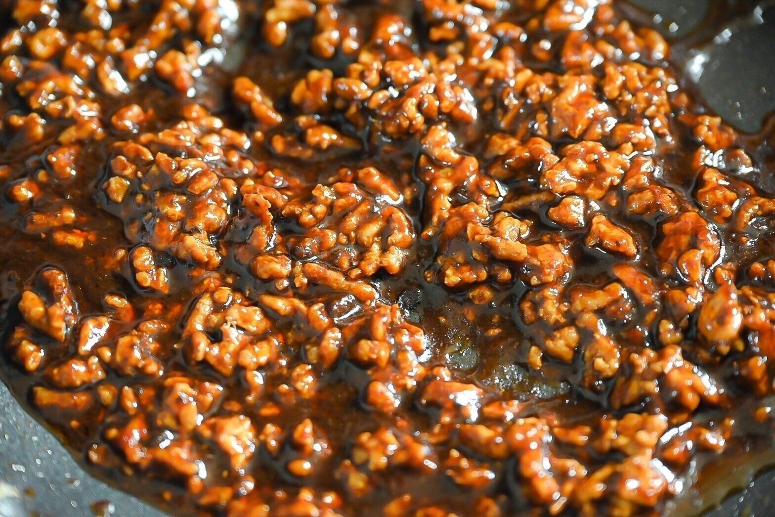 フライパンに入った黒麻婆豆腐の素を絡めた豚ひき肉