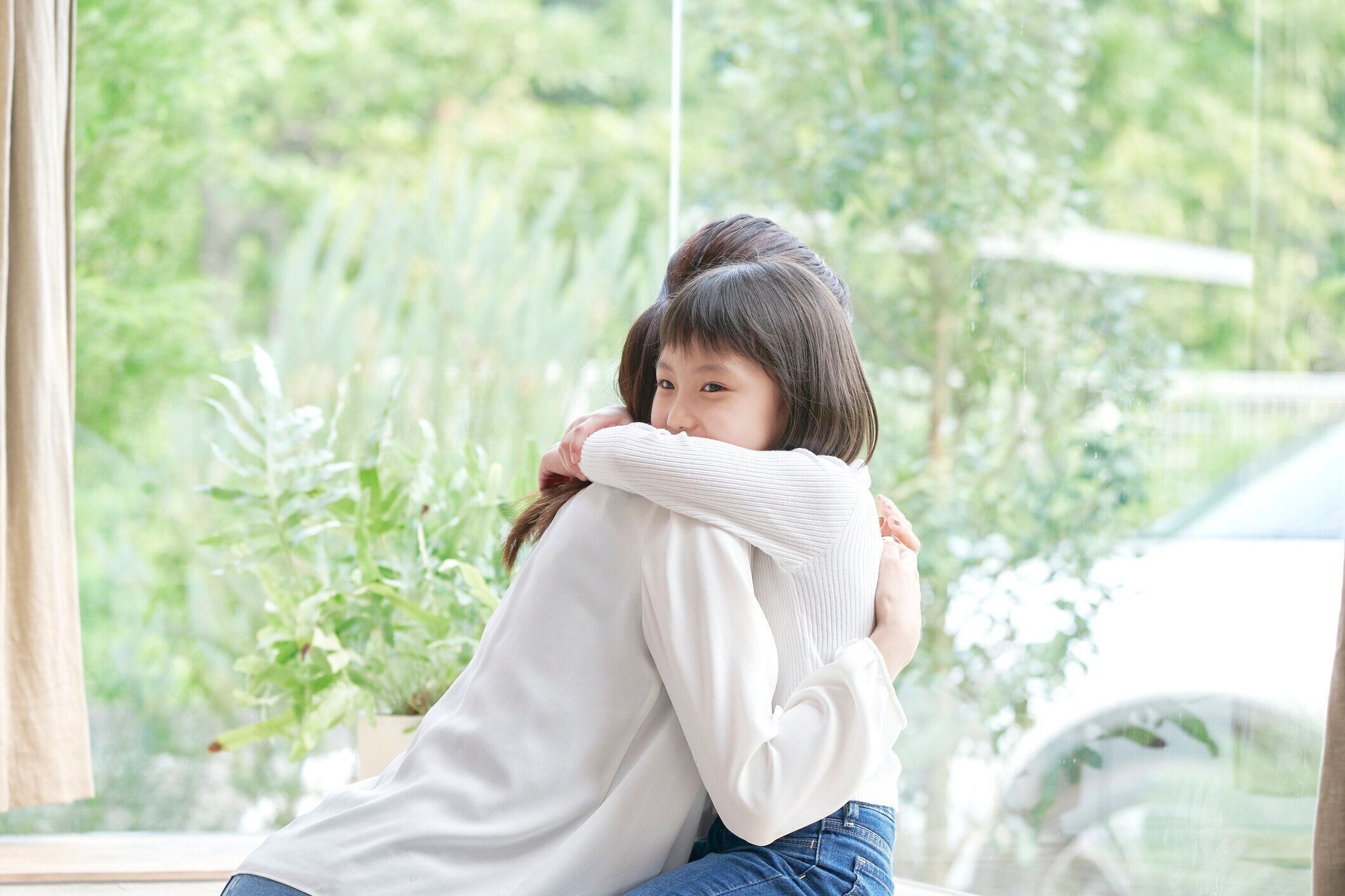 彼女の娘を抱きしめるアジアの母親