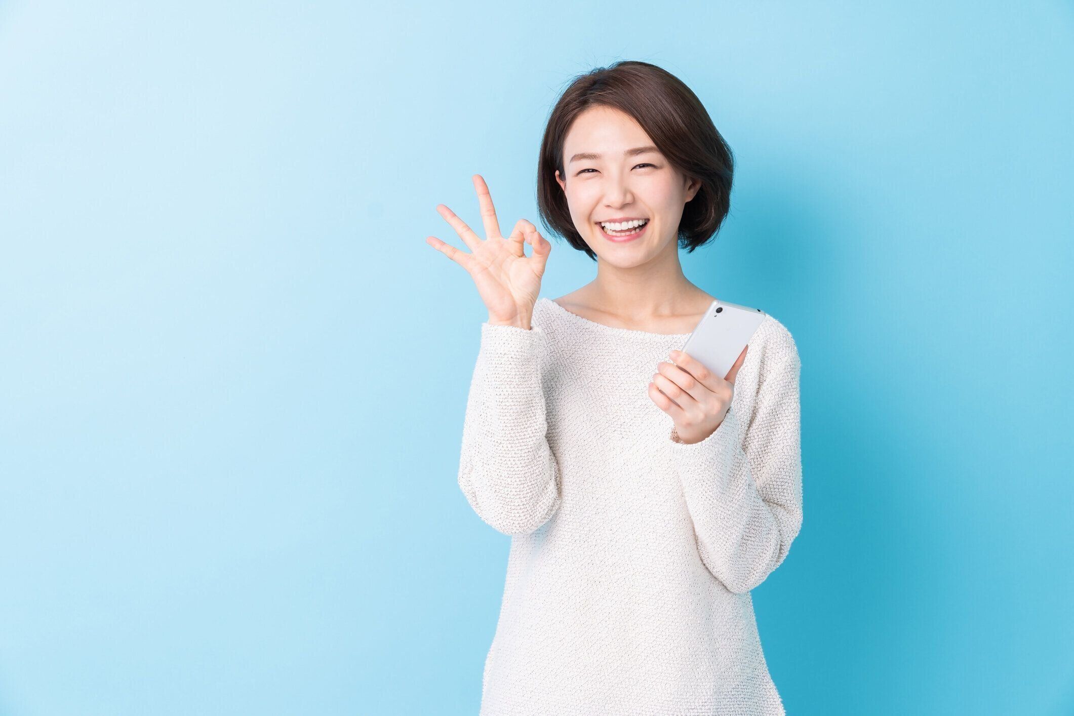 スマートフォンを見る魅力的なアジアの女性