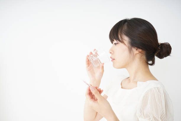 若い女性は、経口薬を飲んで