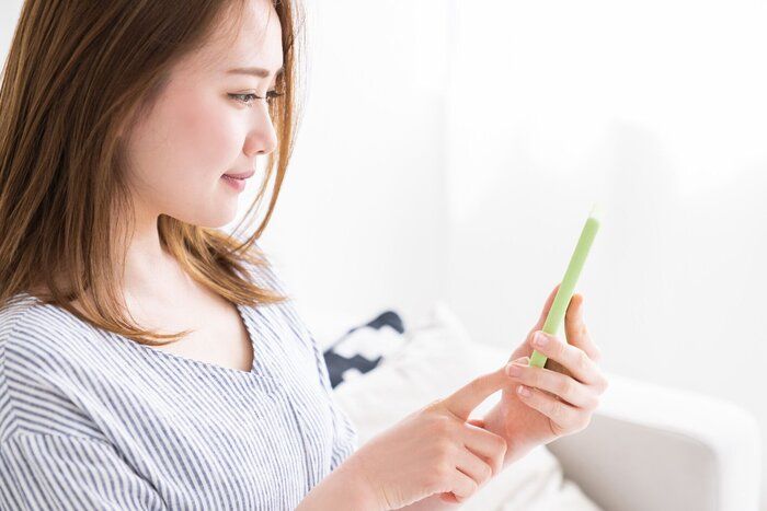 スマートフォンを見るためにアジアの女性